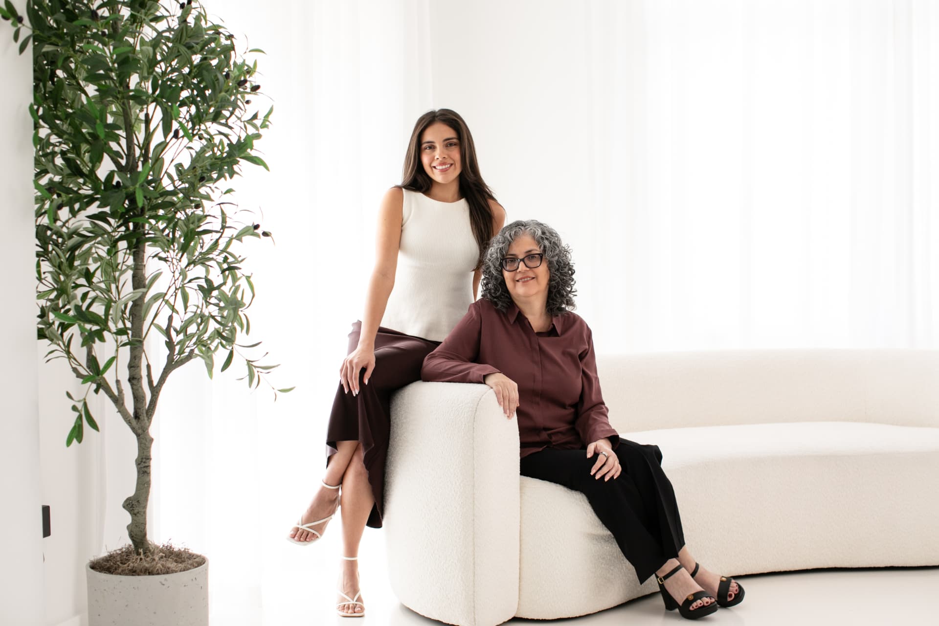 Founders Maria Del Sol and Emily Eidam seated together in a bright studio